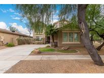 Charming home featuring a well-maintained lawn, desert landscaping, and a cozy two-story facade at 4254 S Winter Ln, Gilbert, AZ 85297