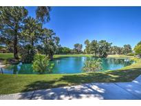 Beautiful serene pond surrounded by mature trees and lush greenery creating a peaceful setting at 5124 N 31St Pl # 514, Phoenix, AZ 85016