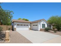 Charming single-story home featuring a three-car garage, desert landscaping, and bright white stucco at 7126 W Ocotillo Rd, Glendale, AZ 85303