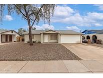 Charming single-story home with a two car garage and low-maintenance desert landscaping at 9920 N 73Rd Ave, Peoria, AZ 85345