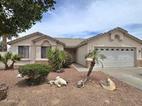 Charming single story home showcasing a low maintenance desert landscape and two-car garage at 1264 W 6Th Ave, Apache Junction, AZ 85120
