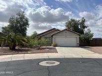 Charming single-story home with a two-car garage and desert landscaping at 14228 N 150Th Ln, Surprise, AZ 85379