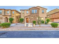 Charming two-story home with a stone facade, well-maintained landscaping, and a cozy entrance at 1624 N 77Th Gln, Phoenix, AZ 85035