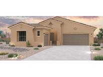 A charming single-story home boasts a desert landscape, neutral-toned exterior, and a spacious two-car garage at 16624 W Ardmore Rd, Goodyear, AZ 85338