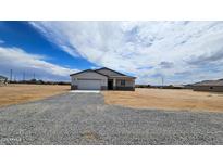 Single-story home featuring desert landscaping and a spacious gravel driveway at 20419 W Mountain Sage Dr, Buckeye, AZ 85326