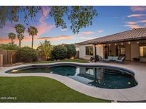 Inviting backyard pool with lush landscaping, perfect for relaxing and entertaining at twilight at 24121 N 24Th Pl, Phoenix, AZ 85024