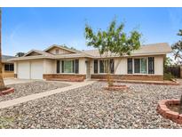 Charming single-story home featuring a low-maintenance rock yard and covered entryway at 3337 W Yucca St, Phoenix, AZ 85029