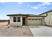 Charming single-story home featuring a two-car garage, stone accents, and low maintenance desert landscaping at 37549 W San Clemente St, Maricopa, AZ 85138