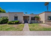 Charming single-story home featuring a well-maintained lawn and a welcoming front entrance at 556 N Hobson Plz, Mesa, AZ 85203