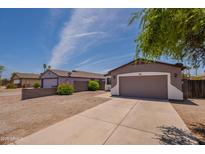 Charming single-story home with a two-car garage, well-maintained landscaping, and a cozy exterior at 719 E Broadway Ave, Apache Junction, AZ 85119