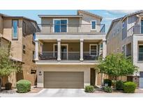 Three-story home with a front-facing two car garage, two balconies, and neutral toned stucco exterior at 732 W Flintlock Way, Chandler, AZ 85286