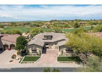 Stunning aerial view of a custom home on a golf course lot with beautiful desert landscaping at 8240 E Wingspan Way, Scottsdale, AZ 85255