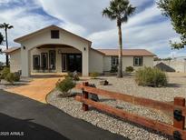 Attractive home with covered entry, mature landscaping, and desert xeriscaping at 920 N 104Th St, Mesa, AZ 85207