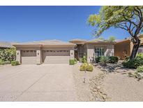 Charming desert home featuring a three-car garage and drought-resistant landscaping at 9562 E Cavalry Dr, Scottsdale, AZ 85262
