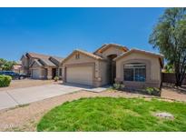 Charming single-Gathering home with a well-manicured lawn and desert landscaping in a suburban neighborhood at 10649 W Alvarado Rd, Avondale, AZ 85392