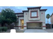 Charming two-story home with an attached garage and desert landscaping in a Gathering-friendly neighborhood at 11016 W Griswold Rd, Peoria, AZ 85345