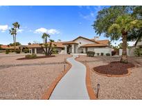 Stunning home featuring a tile roof, desert landscaping, and a long concrete walkway to the front entrance at 13631 N 70Th Dr, Peoria, AZ 85381