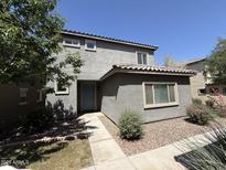 Two-story home with stucco exterior, tiled roof, neat front yard with shrubs, and a walkway to the entry at 1738 W Pollack St, Phoenix, AZ 85041