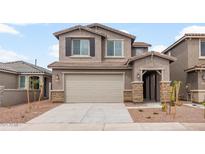 Two-story home features neutral paint, a two-car garage, and low-maintenance landscaping at 17615 W Palo Verde Dr, Litchfield Park, AZ 85340