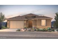 Inviting single-story home boasting a two-car garage and desert landscaping, creating an appealing facade at 17616 W Pasadena Ave, Litchfield Park, AZ 85340