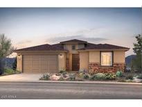Charming single-story home boasts desert landscaping, a two-car garage, and a welcoming entryway at 17674 W Palo Verde Dr, Litchfield Park, AZ 85340