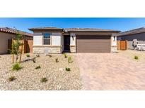 Charming single-story home with desert landscaping and a two-car garage on a sunny day at 18486 E Dario Rd, Gold Canyon, AZ 85118