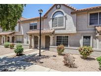 Charming townhome with a stucco facade, red tile roof, and well-maintained landscaping at 1961 N Hartford St # 1055, Chandler, AZ 85225