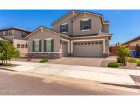 Charming two-story home with neutral stucco, stone accents, and a three-car garage at 20451 E Via De Colina --, Queen Creek, AZ 85142