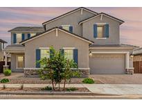 Charming home with neutral stucco, stone accents, and a gray three-car garage at 20451 E Via De Colina --, Queen Creek, AZ 85142