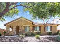 Inviting single-story home featuring stone accents, desert landscaping, and a welcoming covered entryway at 2475 E Vermont Dr, Gilbert, AZ 85295