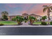 Stunning stone home with a circular turret, lush landscaping, and paver walkway leading to the front door at 2892 E Fruitvale Ave, Gilbert, AZ 85297