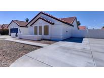 Charming single-story home showcasing desert landscaping, concrete driveway and neutral exterior paint at 2940 E Norwood St, Mesa, AZ 85213
