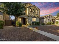 Charming two-story home with a desert landscape and illuminated pathway to the front door at 3476 E Orchid Ln, Gilbert, AZ 85296