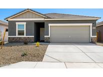 Charming single-story home with a gray exterior, stone accents, and a well-maintained front yard at 38099 N Stallion St, San Tan Valley, AZ 85140