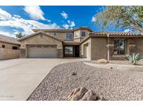 Charming home featuring a spacious three-car garage, stone accents, desert landscaping, and tile roof at 4336 W Hackamore Dr, Phoenix, AZ 85083