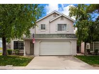 Charming two-story home featuring a two-car garage, a well-manicured lawn, and mature trees in a residential neighborhood at 441 S Maple -- # 83, Mesa, AZ 85206