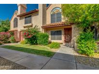 Inviting townhome featuring well-maintained landscaping and a private entrance with a charming walkway at 4901 E Kelton Ln # 1052, Scottsdale, AZ 85254