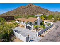 Stunning modern home with mountain views, a private balcony, and a stylish garage door at 5801 E Surrey Dr, Cave Creek, AZ 85331