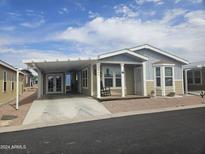 Charming home featuring covered parking, landscaped yard and a welcoming front porch at 650 N Hawes Rd # 3604, Mesa, AZ 85207
