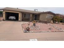 Charming front exterior features a landscaped yard and covered parking at 962 S Main Dr, Apache Junction, AZ 85120