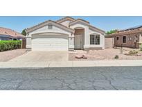 Charming single-story home featuring a stucco exterior, a two-car garage and low maintenance desert landscaping at 11154 W Ashley Chantil Dr, Surprise, AZ 85378