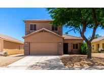 Charming two-story home featuring a neutral color scheme, well-maintained landscaping, and a two-car garage in a sunny neighborhood at 15427 W Port Au Prince Ln, Surprise, AZ 85379