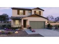 Charming two-story home with a two-car garage, landscaped front yard, and neutral color palette at 15634 W Hackamore Dr, Surprise, AZ 85387