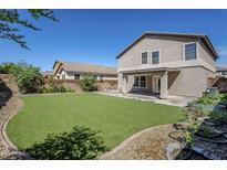 This backyard has an expansive lawn and patio area for relaxing and entertaining at 1839 E Parkside Ln, Phoenix, AZ 85024