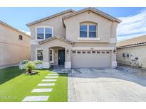 Charming two-story home features manicured lawn, walkway, and two-car garage at 1839 E Parkside Ln, Phoenix, AZ 85024