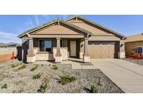 Charming single-story home with stone accents, a two-car garage, and low-maintenance landscaping at 19026 W Stella Ave, Waddell, AZ 85355