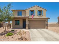 Two-story home with tan stucco, blue shutters, landscaping and an American flag at 21648 W Ashleigh Marie St, Buckeye, AZ 85326