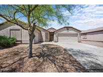 Charming single-story home featuring a well-maintained yard with a spacious driveway and three car garage at 22926 W Yavapai St, Buckeye, AZ 85326
