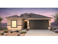 Charming single-story home featuring a two-car garage, desert landscaping, and a neutral-toned exterior at 25200 W Wier Ave, Buckeye, AZ 85326
