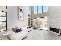 Bright living room with high ceilings, fireplace, and expansive windows that bring the outdoors in at 25555 N Windy Walk Dr # 64, Scottsdale, AZ 85255